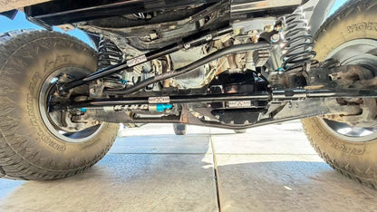 Installed underside view of BAD AXE steering system on lifted Ram